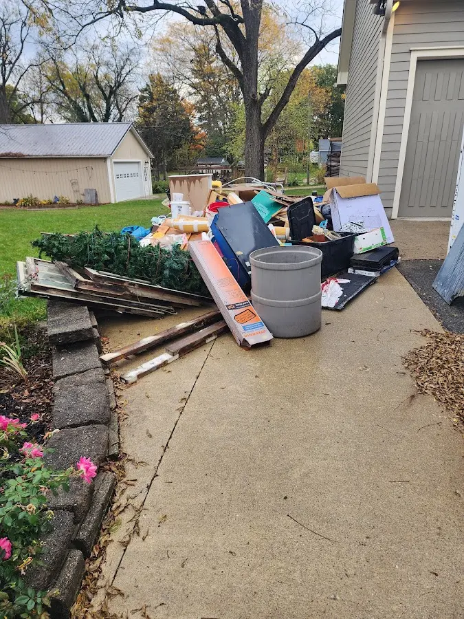 Dumpster being loaded with debris for Roofing Dumpster Rental in Blooming Grove